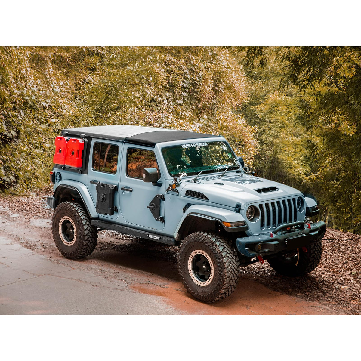 Jeep with two red containers attached to an exterior rear-window MOLLE panel